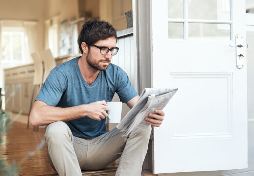Cropped shot of a handsome young man enjoying his coffee while reading the morning paper